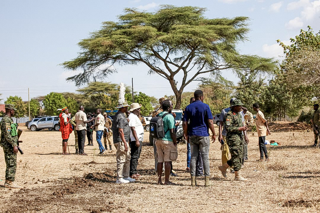 Festival participants and security representatives during a field engagement in Moroto