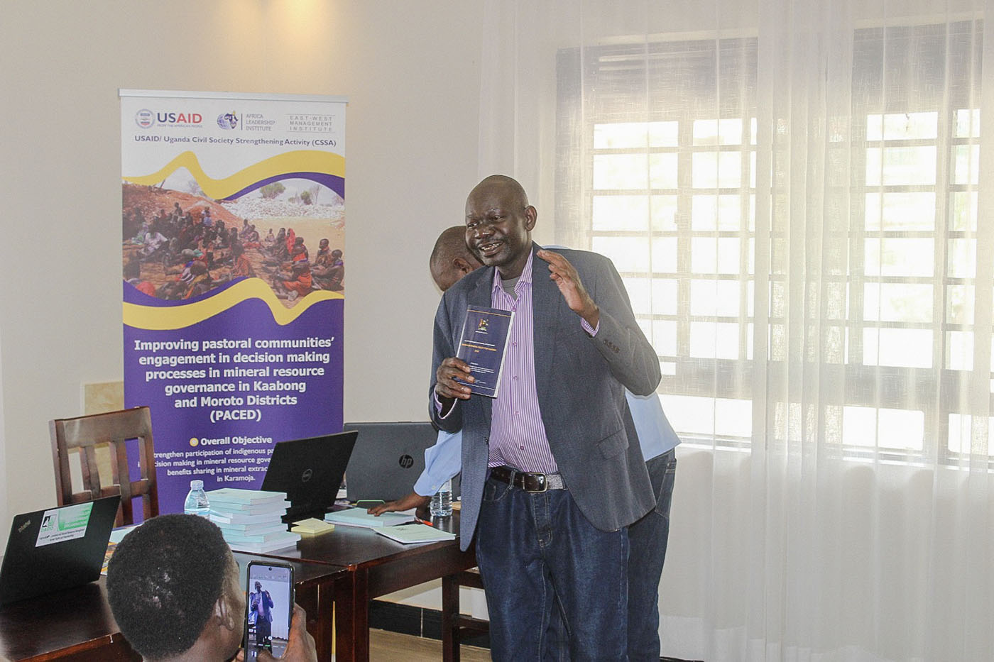 A speaker presenting during a PACED programme meeting