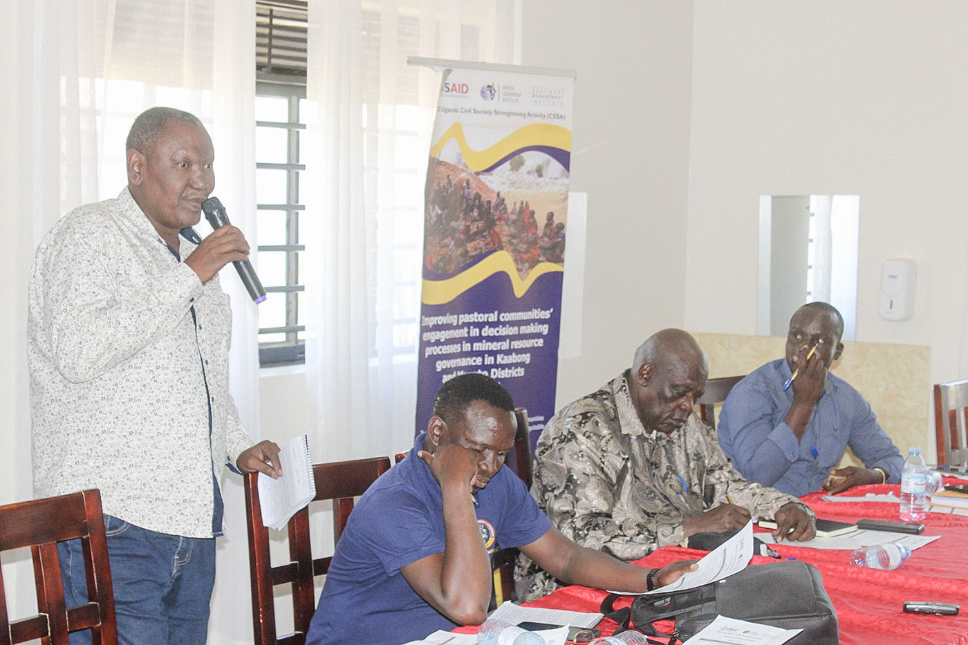 A facilitator addressing participants during a PACED programme workshop